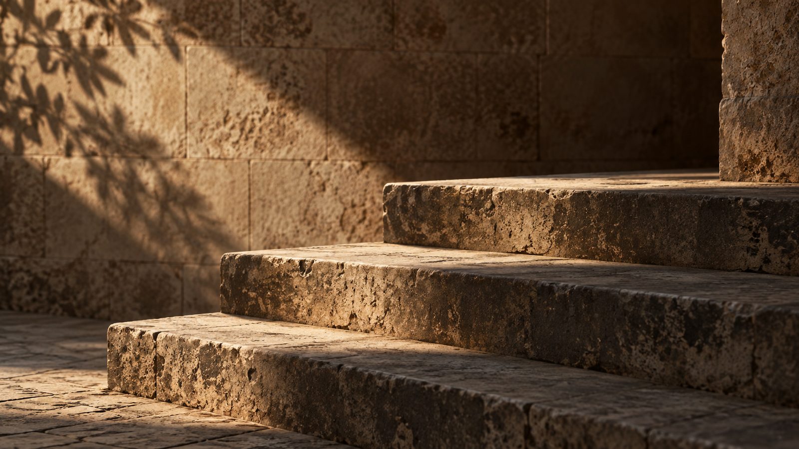 Worn stone steps lit from the side, an image for a lesson on support, resistance and structure